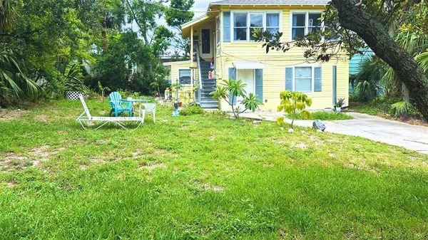 a view of a house with backyard porch and sitting area