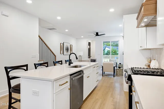 a kitchen with a sink a stove and cabinets