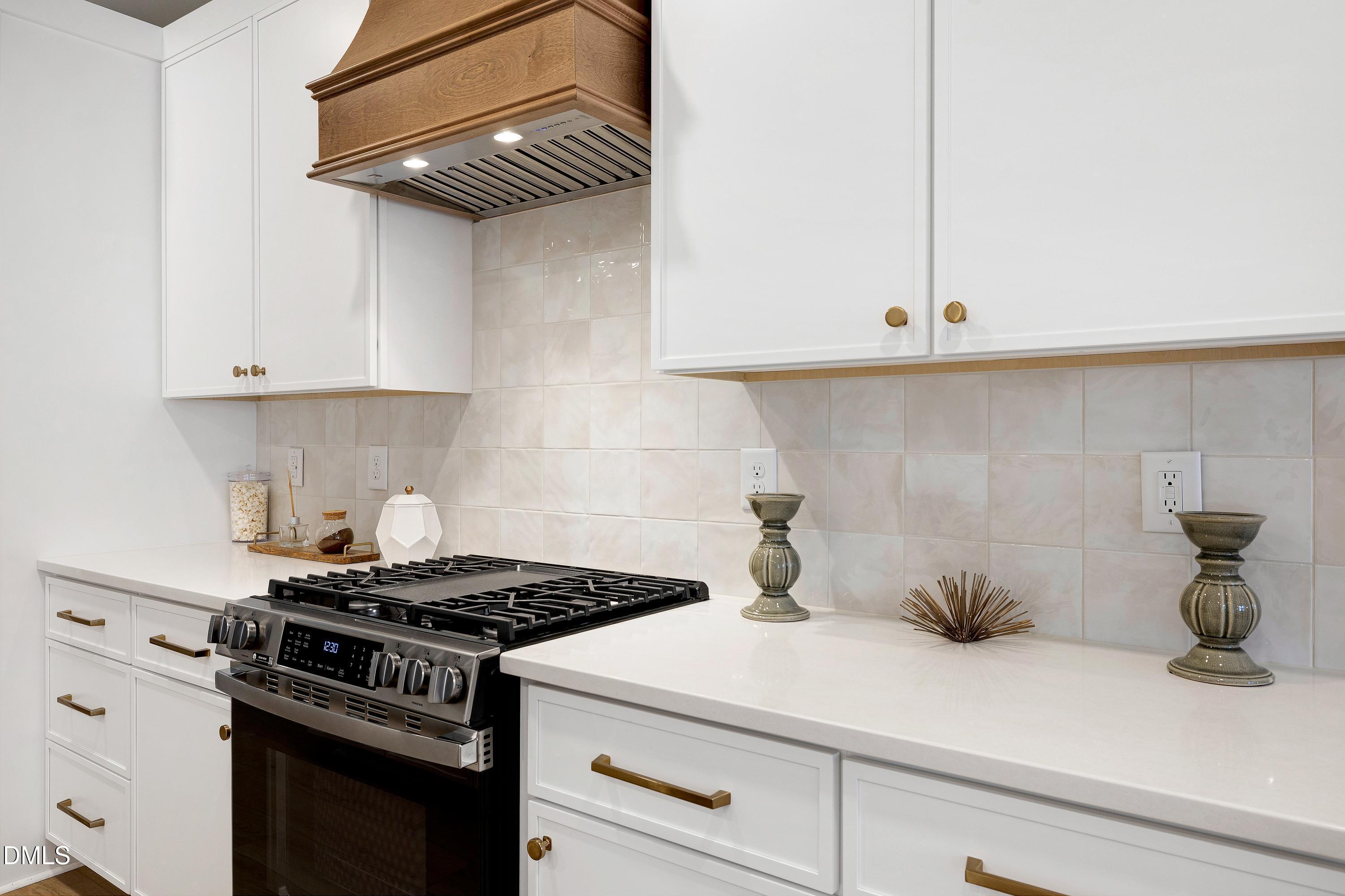 1418 Joe Louis Avenue Raleigh, NC 27610 - Photo 12 of 49 a kitchen with a stove and cabinets