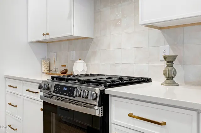 a stove top oven sitting inside of a kitchen