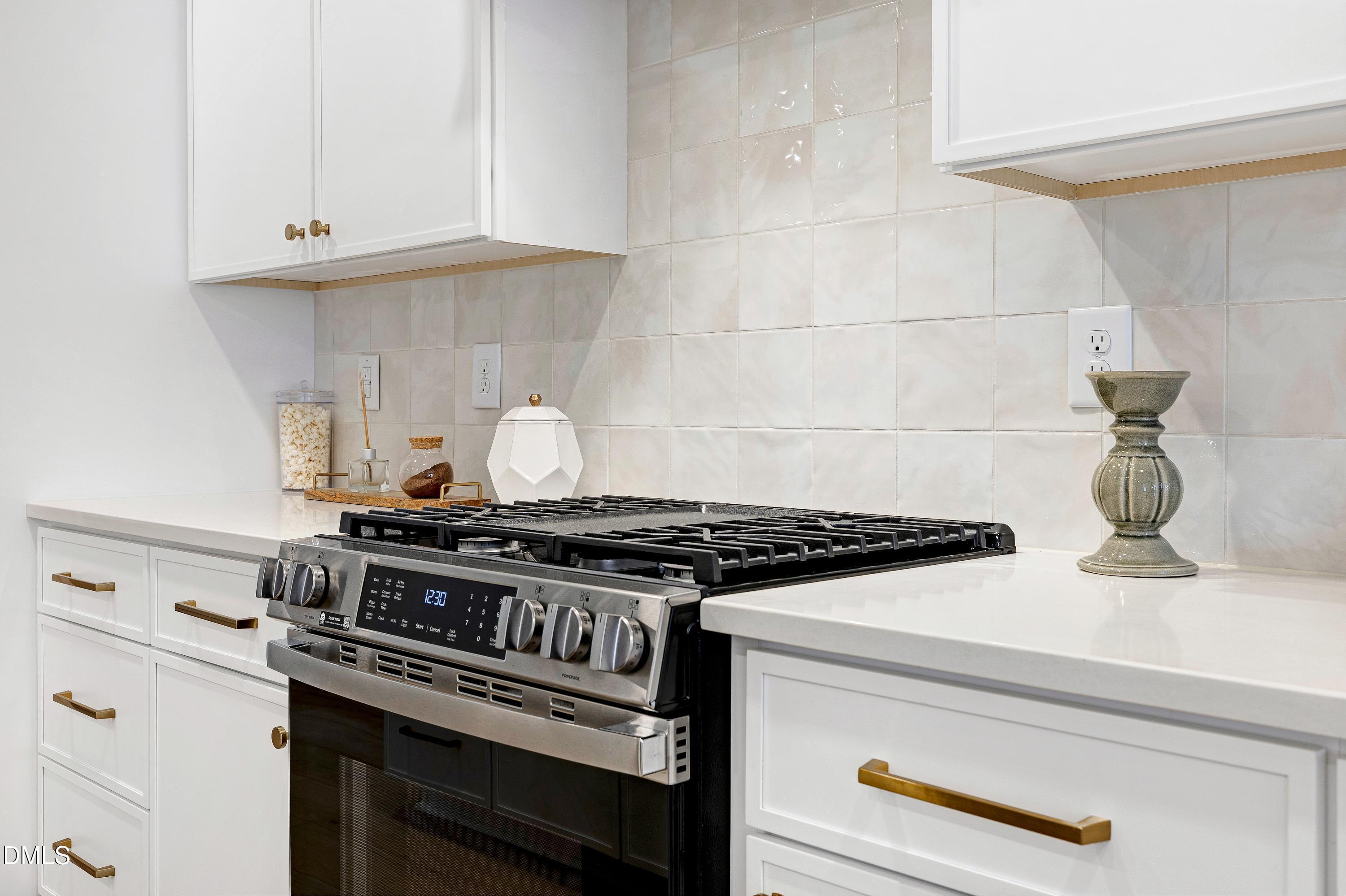 1418 Joe Louis Avenue Raleigh, NC 27610 - Photo 13 of 49 a stove top oven sitting inside of a kitchen