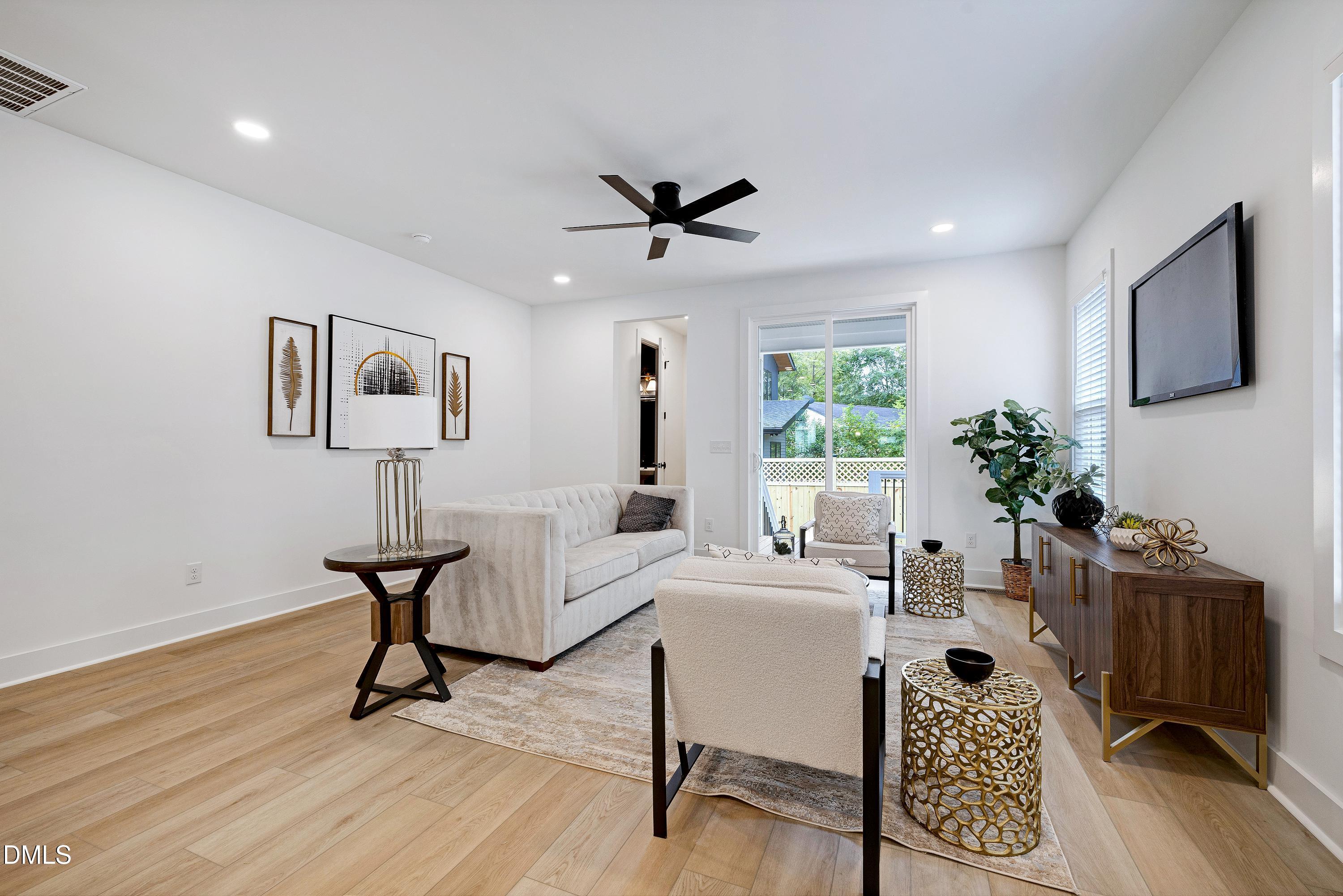 1418 Joe Louis Avenue Raleigh, NC 27610 - Photo 19 of 49 a living room with furniture a window and a potted plant