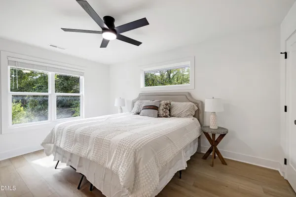 a bedroom with a bed and a large window