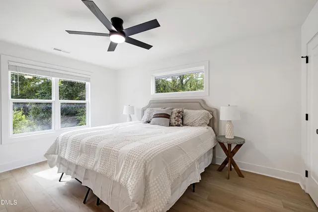 a bedroom with a bed and a large window