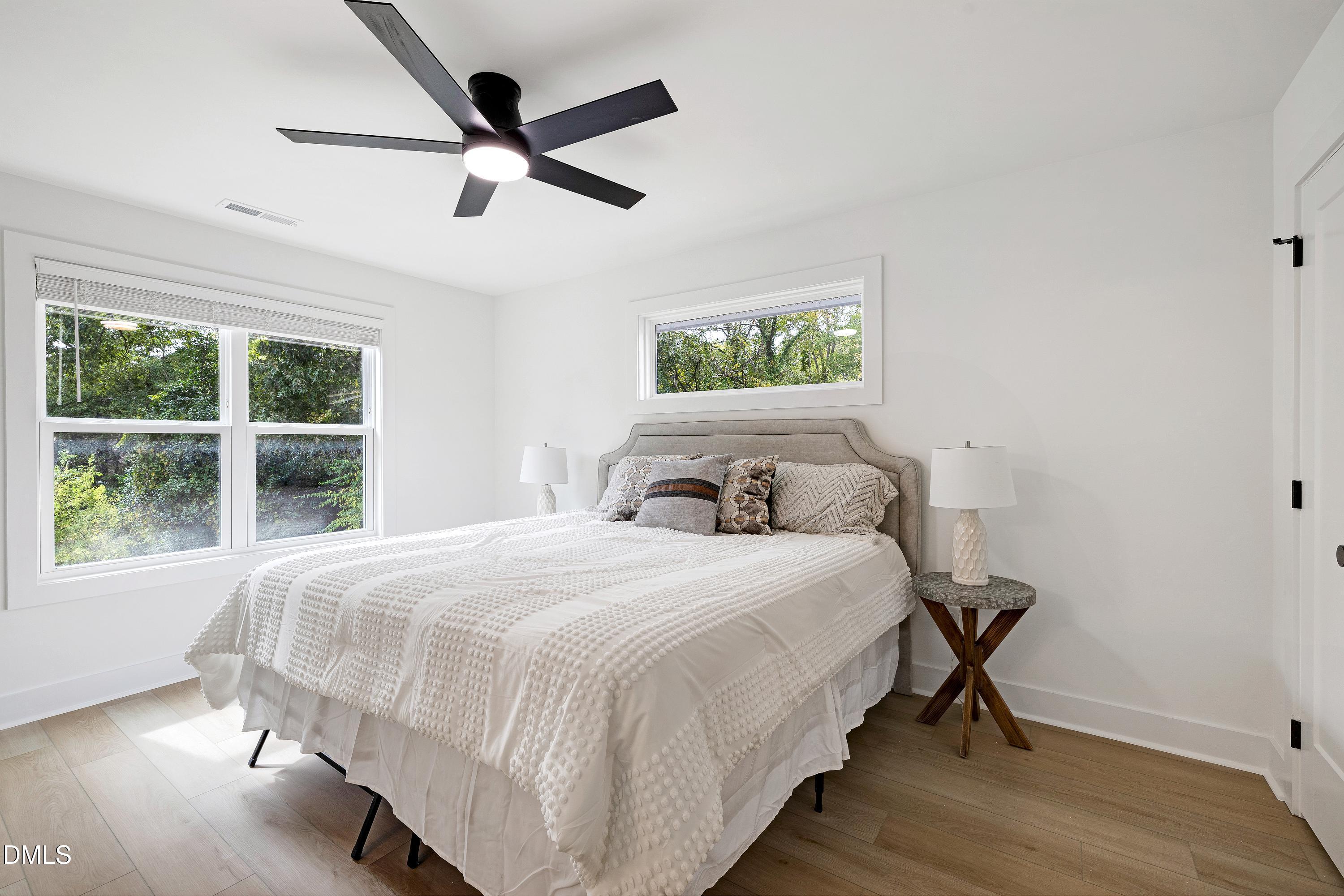 1418 Joe Louis Avenue Raleigh, NC 27610 - Photo 24 of 49 a bedroom with a bed and a large window