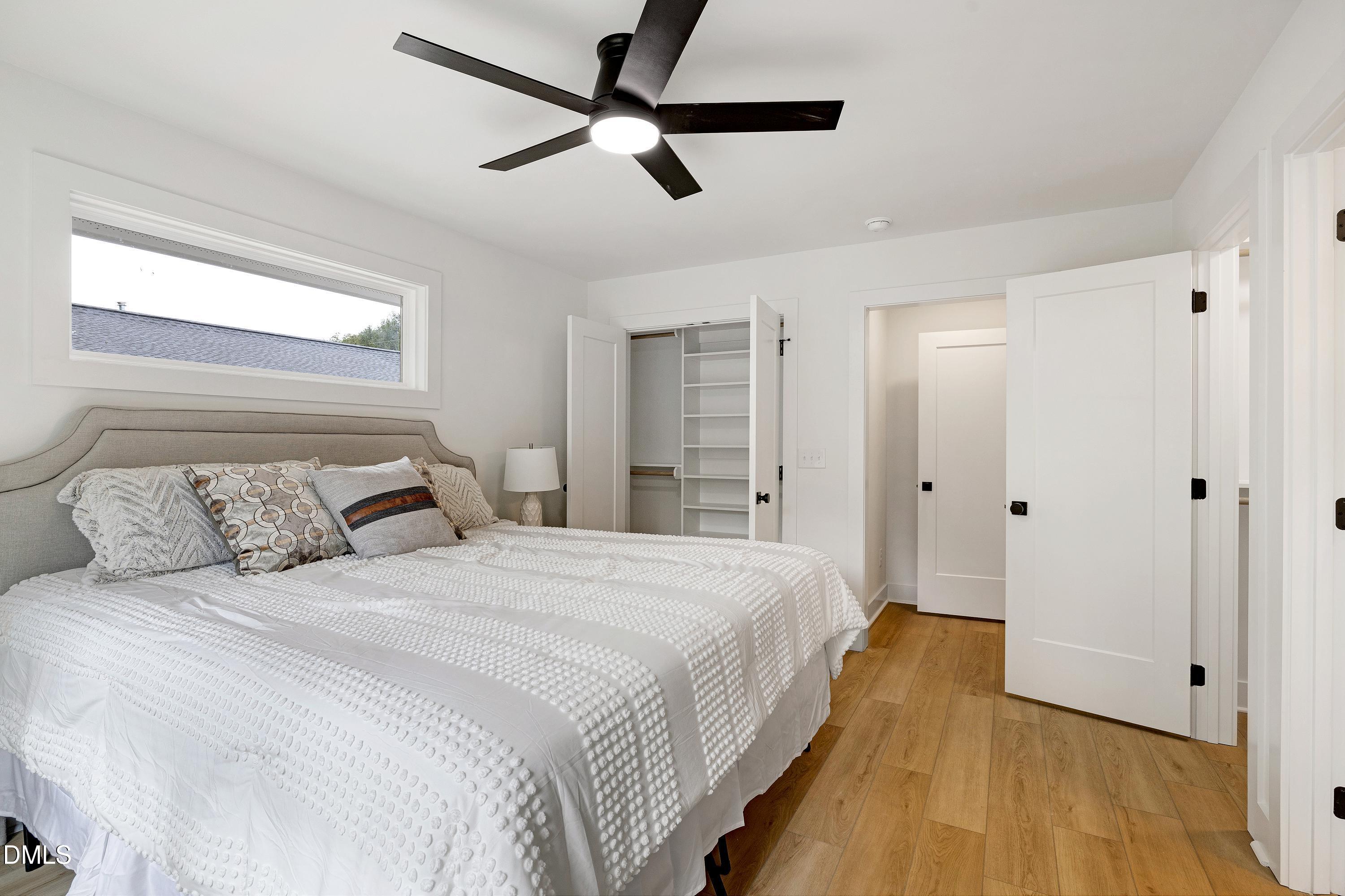 1418 Joe Louis Avenue Raleigh, NC 27610 - Photo 25 of 49 a bedroom with a bed and a ceiling fan
