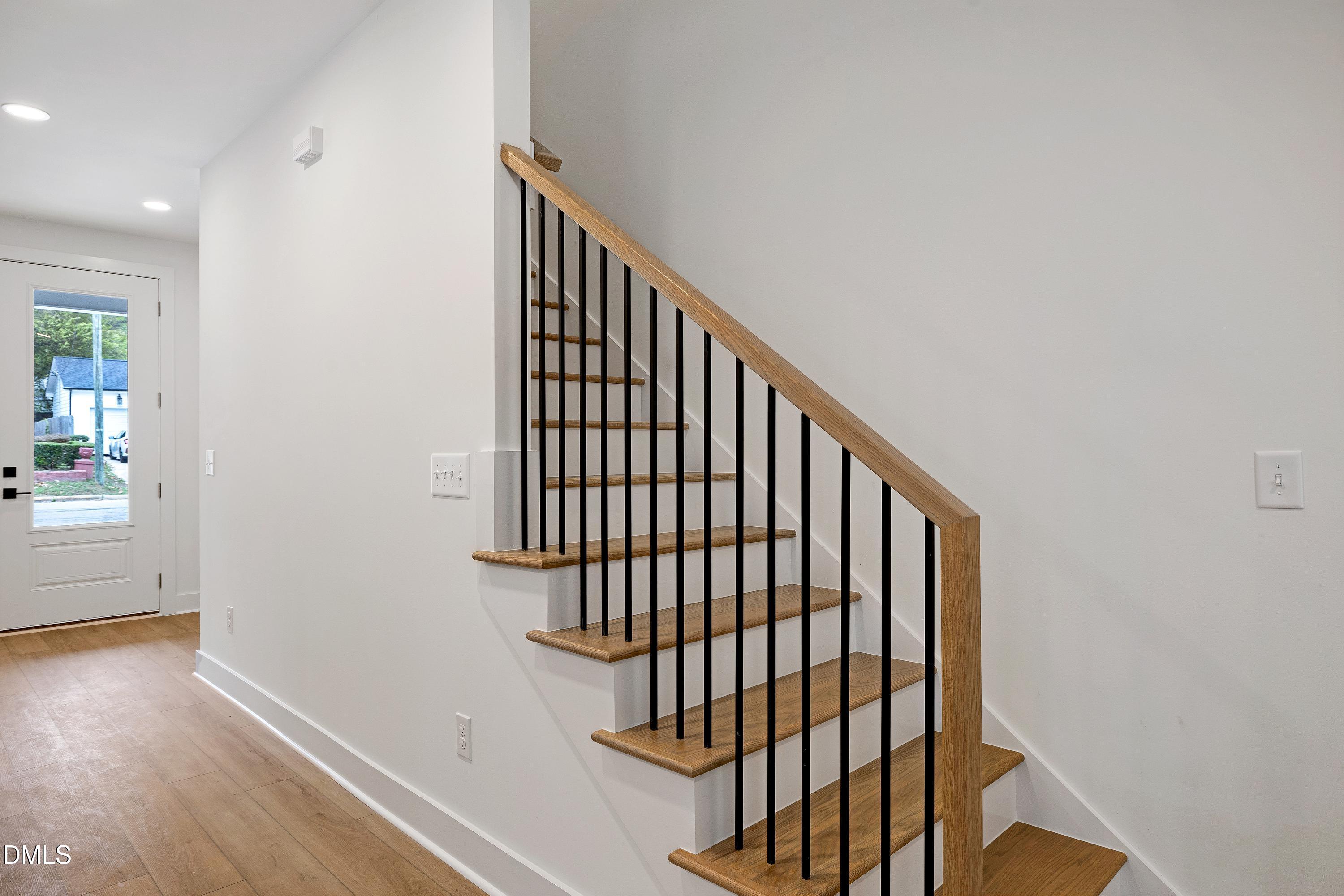 1418 Joe Louis Avenue Raleigh, NC 27610 - Photo 29 of 49 a view of staircase with railing and a rug