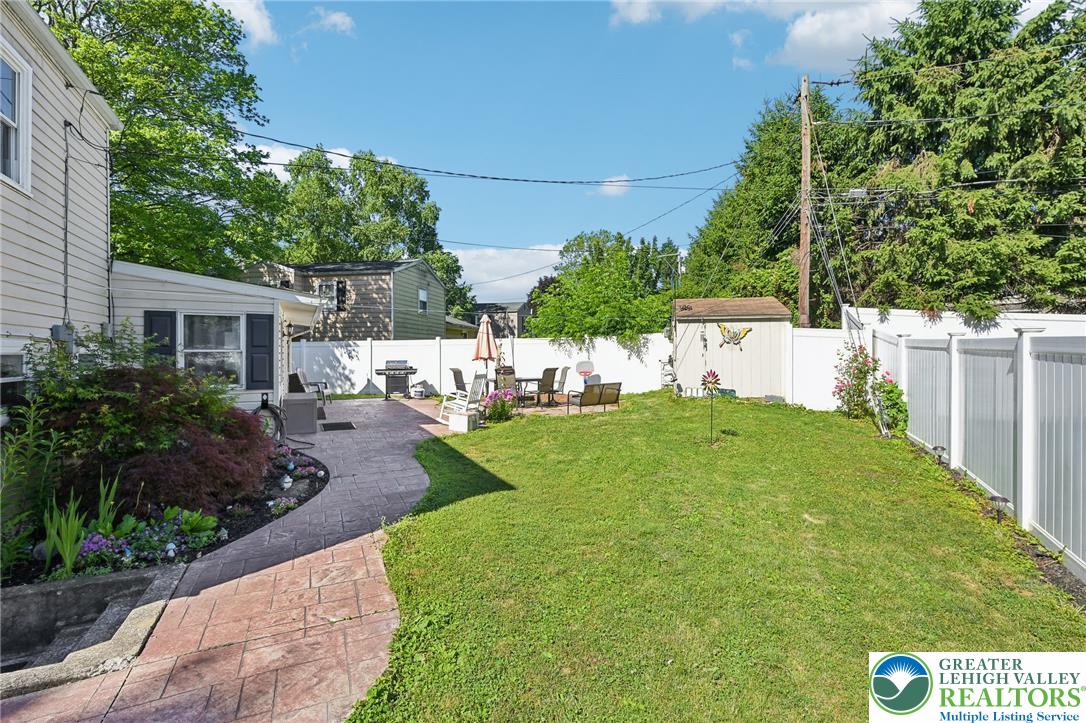 2649 Nottingham Road Bethlehem, PA 18017 - Photo 31 of 49 An inviting backyard oasis awaits with a spacious patio, lush lawn, and charming landscaping.