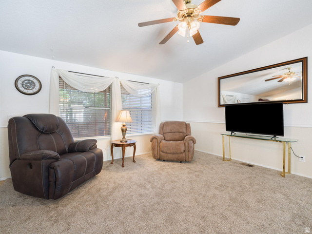 3941 West 40 North Hurricane, UT 84737 - Photo 10 of 55 Spacious living area featuring neutral carpeting, a ceiling fan with integrated lighting, and white walls with wainscoting