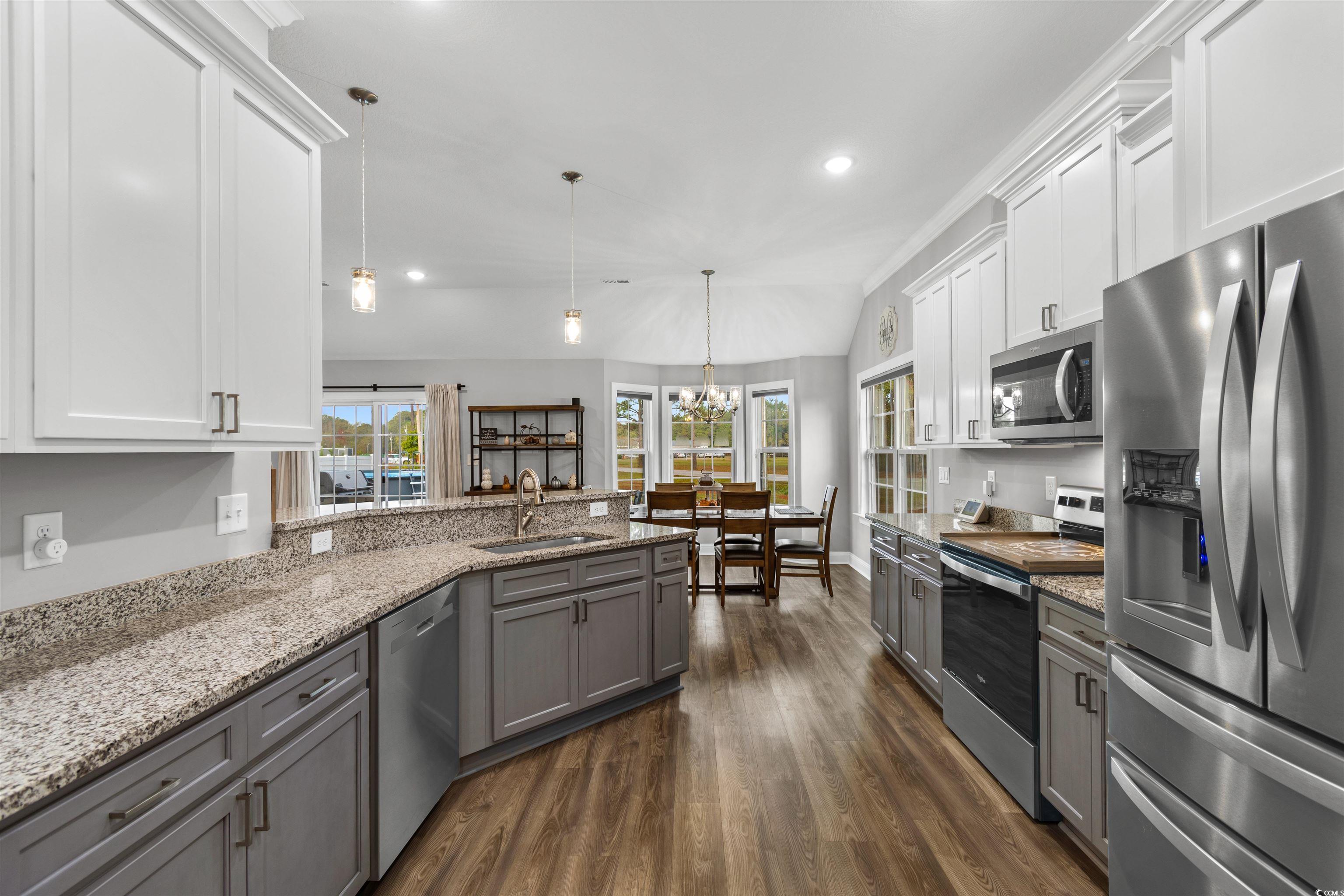 2299 Vaught Road Galivants Ferry, SC 29544 - Photo 11 of 40 Kitchen with white cabinetry, appliances with stai