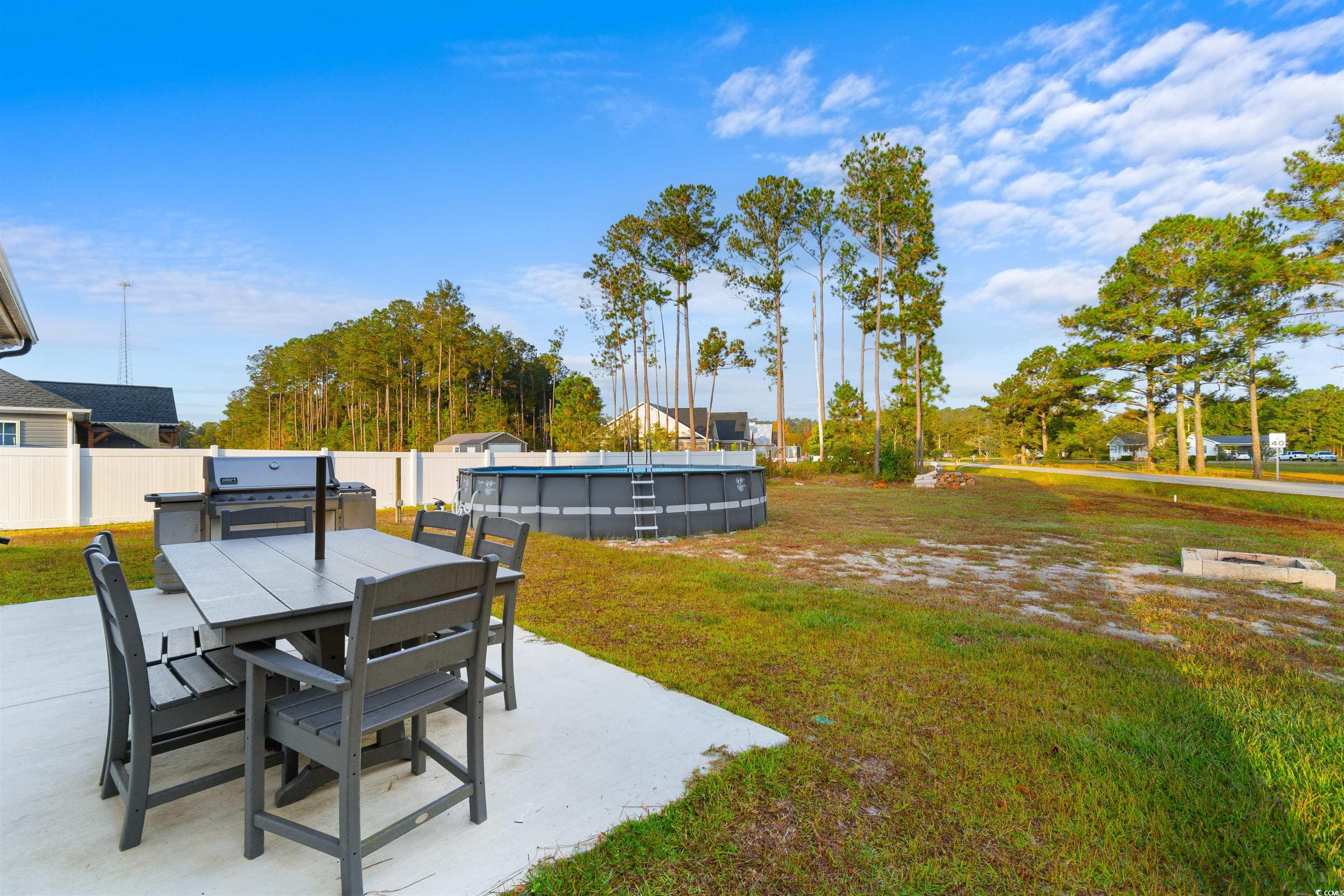 2299 Vaught Road Galivants Ferry, SC 29544 - Photo 31 of 40 View of yard with a fenced in pool and a patio are