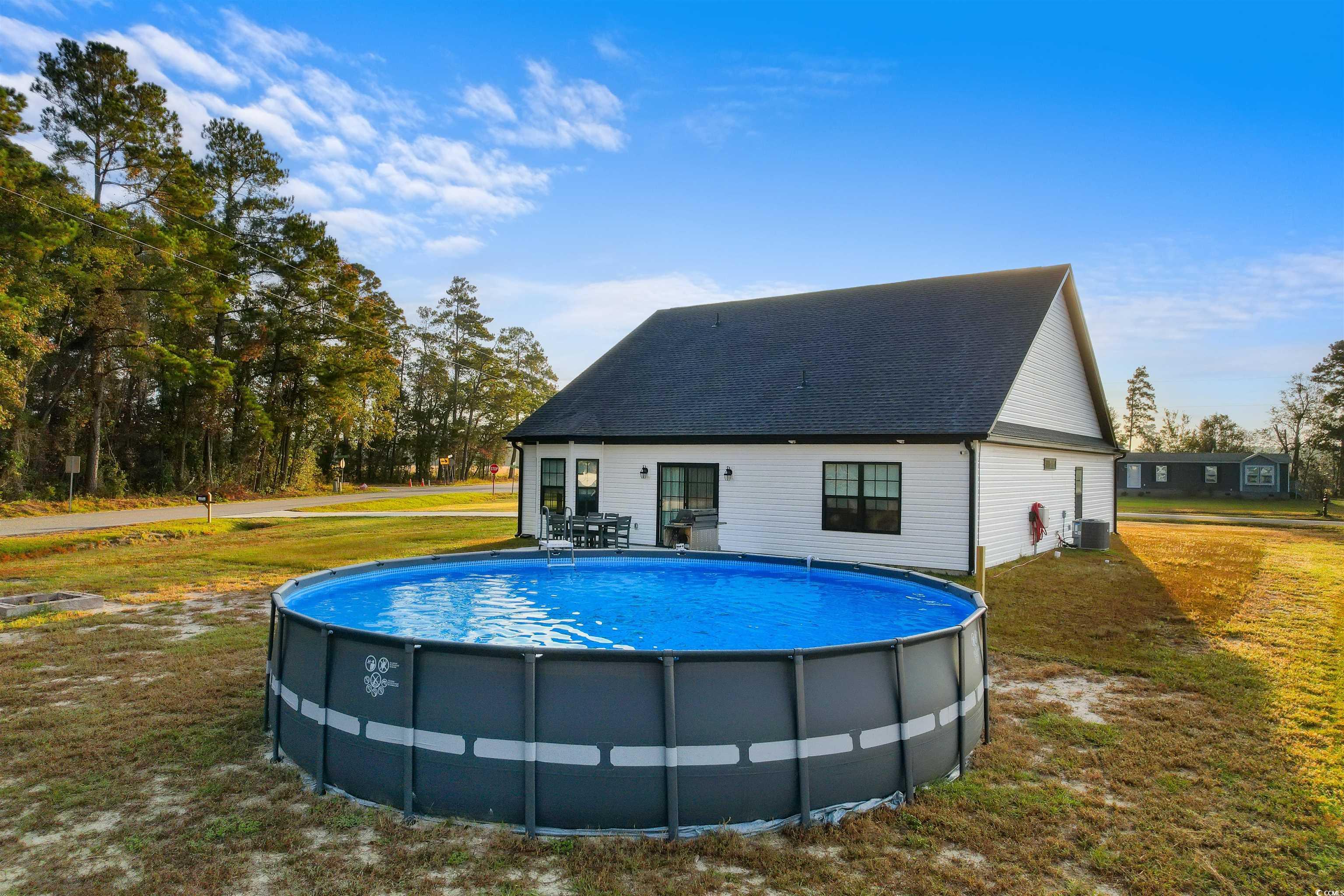 2299 Vaught Road Galivants Ferry, SC 29544 - Photo 32 of 40 View of pool with a yard and cooling unit