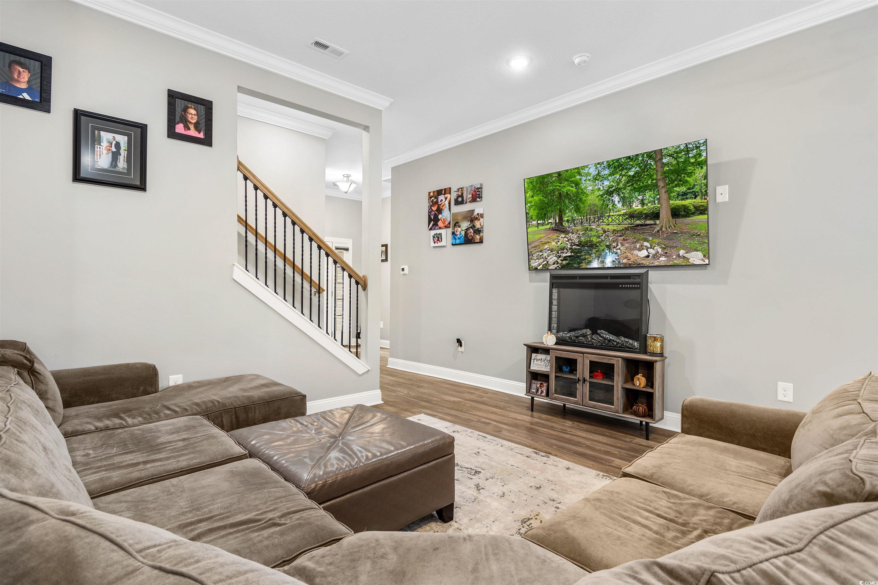 2299 Vaught Road Galivants Ferry, SC 29544 - Photo 8 of 40 Living room featuring wood-type flooring and crown
