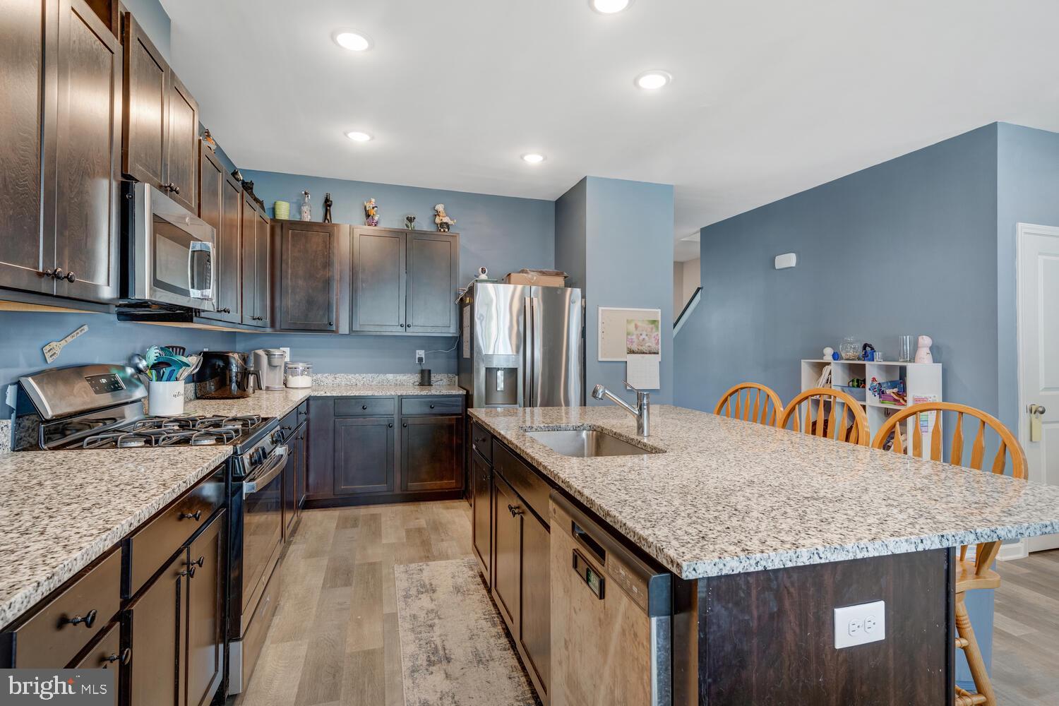 107 Sandpiper Lane Little Egg Harbor, NJ 08087 - Photo 11 of 40 a kitchen with granite countertop stainless steel appliances a sink dishwasher a refrigerator a stove top oven with wooden floor