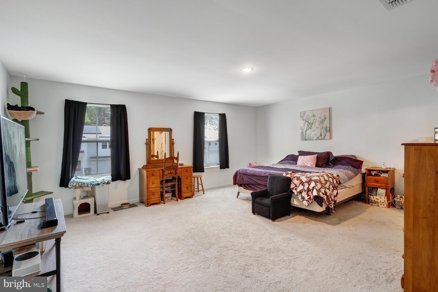 107 Sandpiper Lane Little Egg Harbor, NJ 08087 - Photo 25 of 40 a spacious bedroom with a bed and dresser