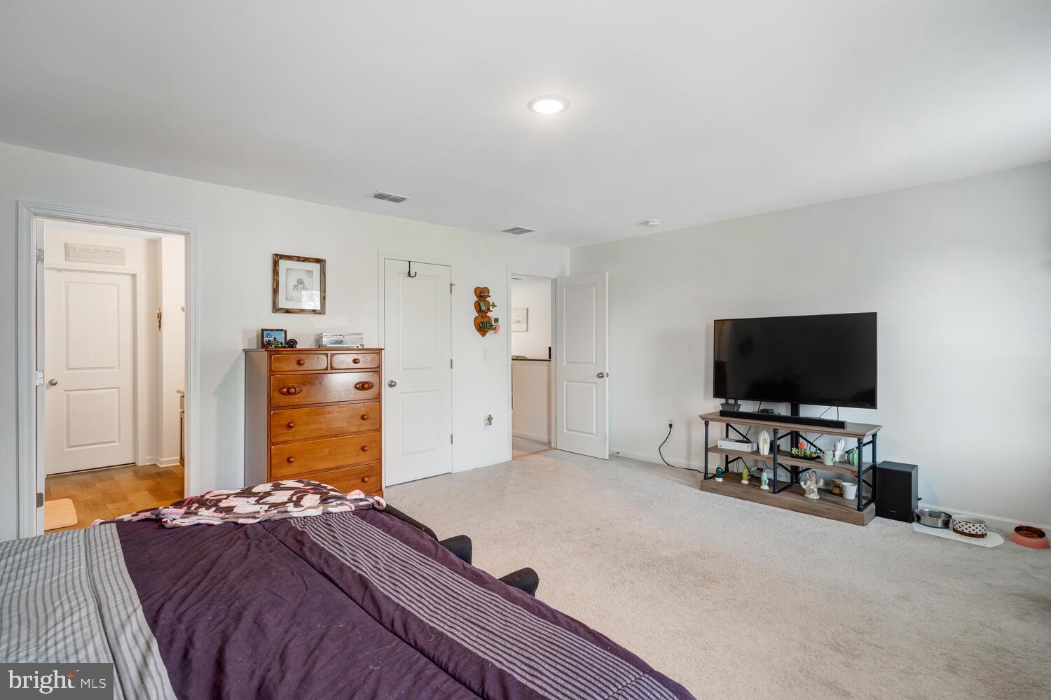 107 Sandpiper Lane Little Egg Harbor, NJ 08087 - Photo 26 of 40 a bedroom with a bed and a flat screen tv