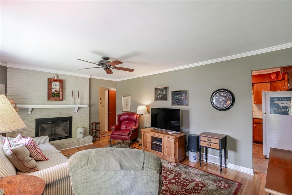 302 Radliff Road Bloomington, IL 61701 - Photo 6 of 35 a living room with furniture a fireplace and a flat screen tv