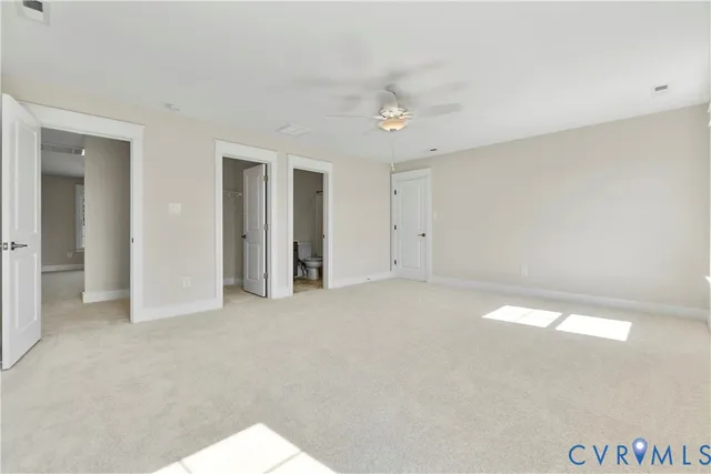 an empty room with windows and entrance