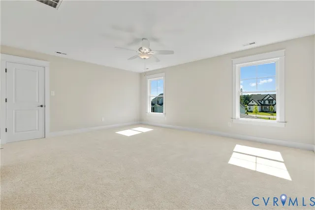 an empty room with windows and closet