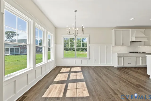 a view of a kitchen with wooden floor and windows