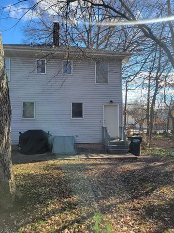 a view of a house with a yard and garage
