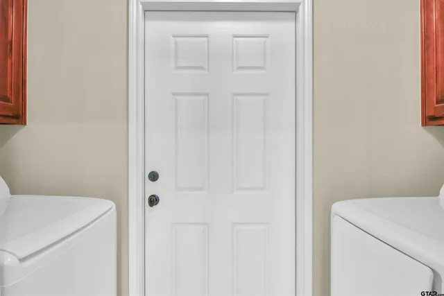 a view of bathroom with washer and dryer