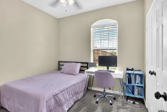 a bedroom with a bed and a book shelf