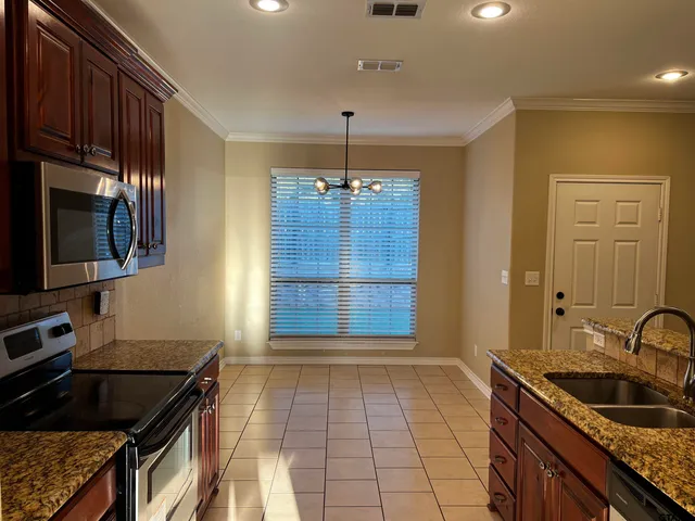 a kitchen that has a sink and a stove in it