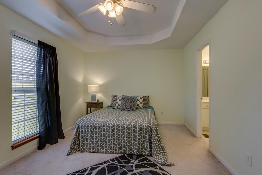 1427 St Paul Road Charlotte, TN 37036 - Photo 15 of 27 a bedroom with a large bed and a chandelier