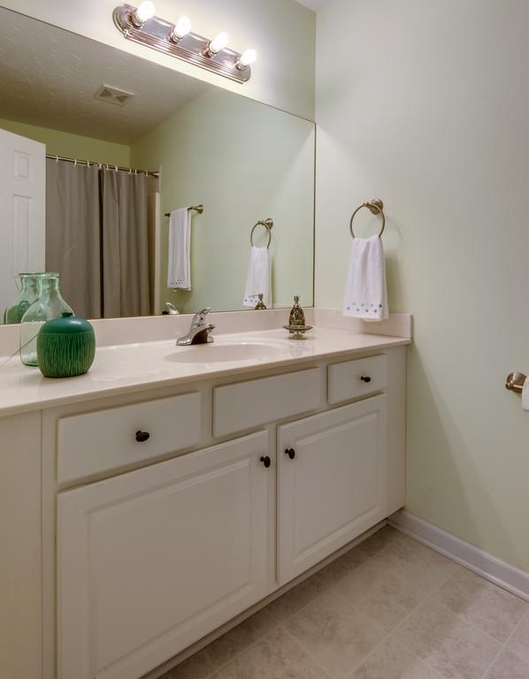 1427 St Paul Road Charlotte, TN 37036 - Photo 17 of 27 a bathroom with a sink and mirror