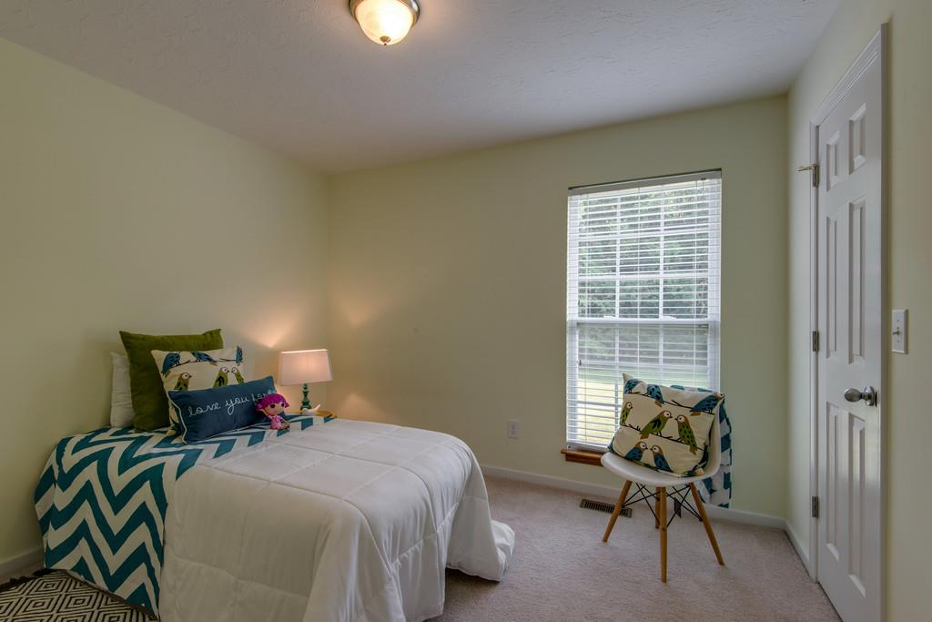 1427 St Paul Road Charlotte, TN 37036 - Photo 19 of 27 a bed room with a bed and a chair