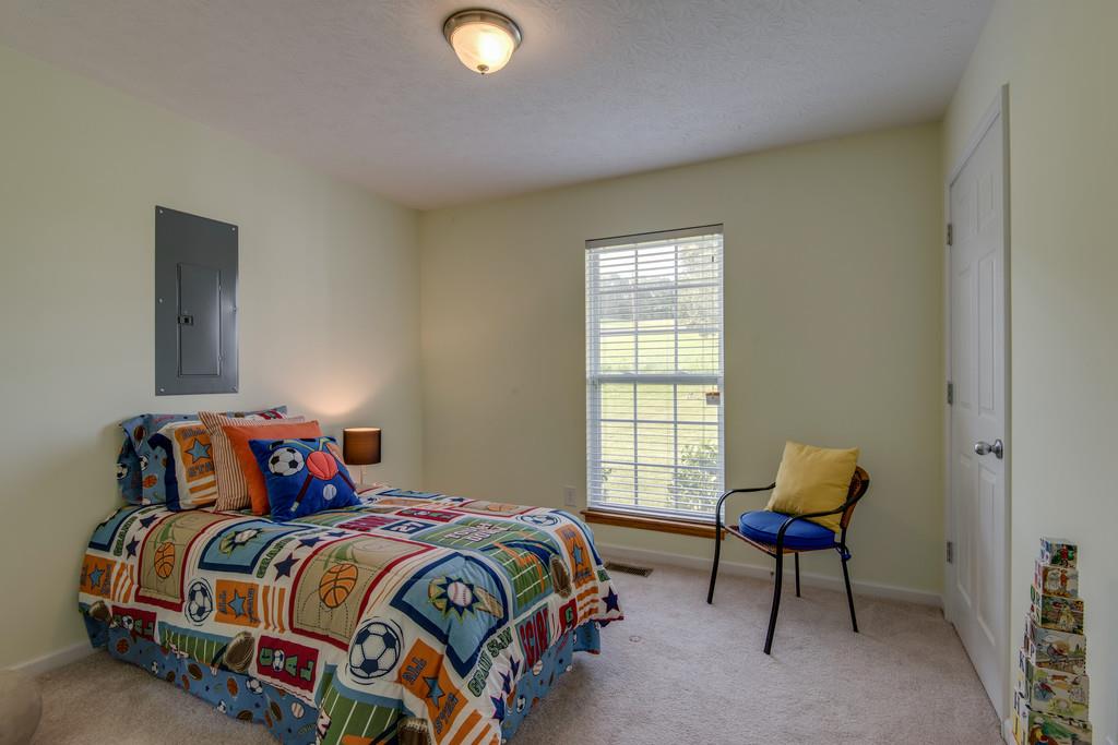 1427 St Paul Road Charlotte, TN 37036 - Photo 21 of 27 a bedroom with a bed and window