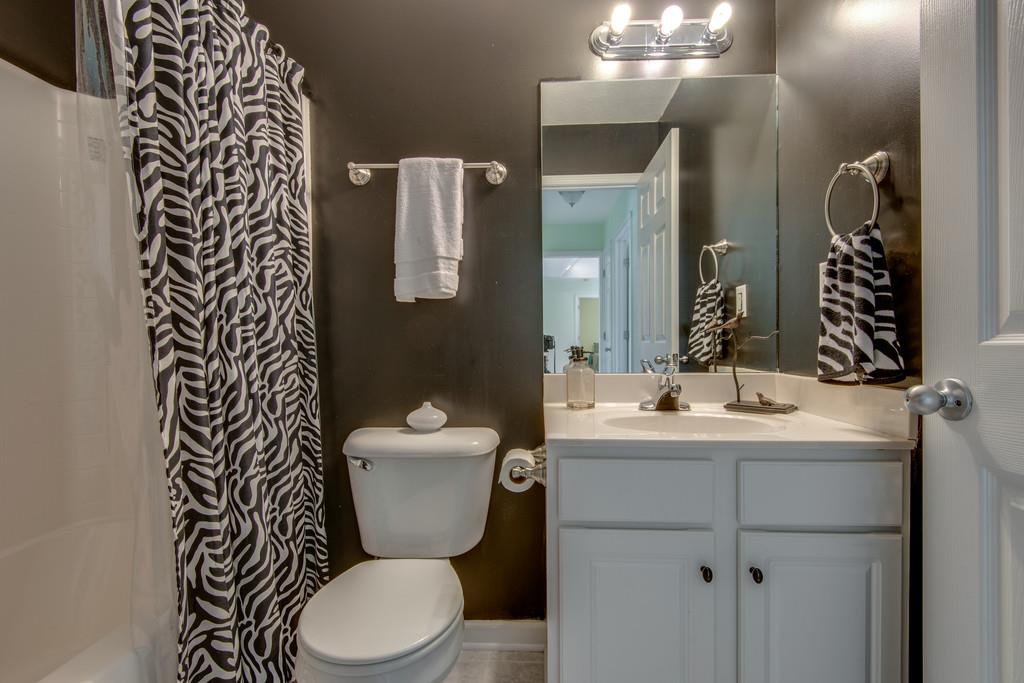 1427 St Paul Road Charlotte, TN 37036 - Photo 23 of 27 a bathroom with a toilet sink and mirror