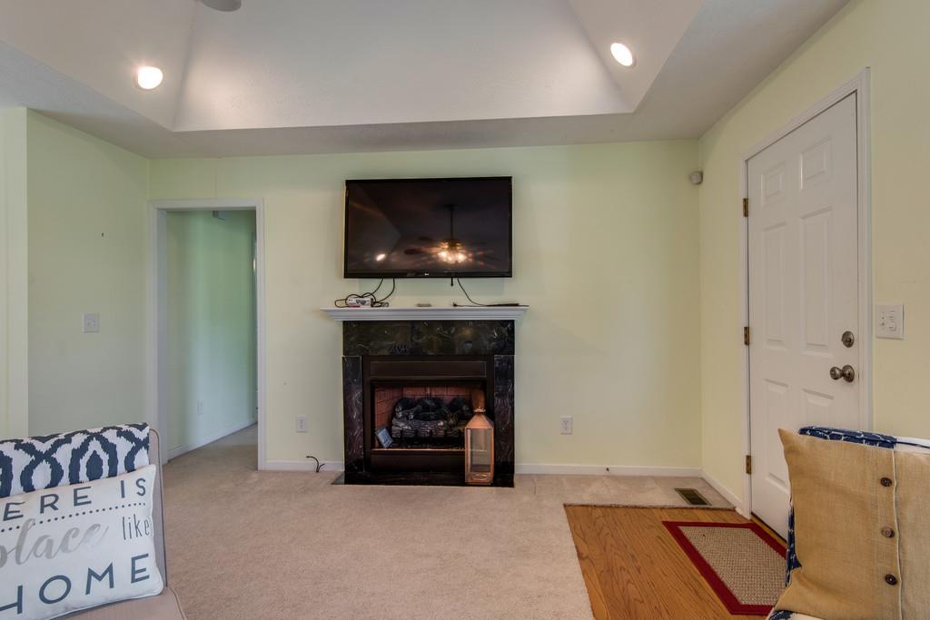 1427 St Paul Road Charlotte, TN 37036 - Photo 9 of 27 a living room with furniture and a fireplace