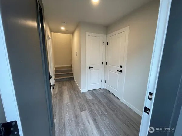 a view of a hallway with wooden floor
