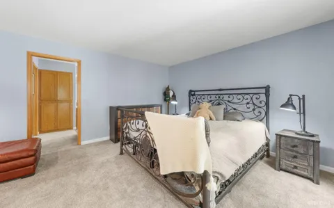 a bed sitting in a bedroom next to a window