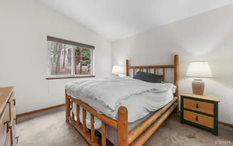 a bedroom with a bed and a night stand