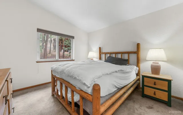 a bedroom with a bed and a night stand