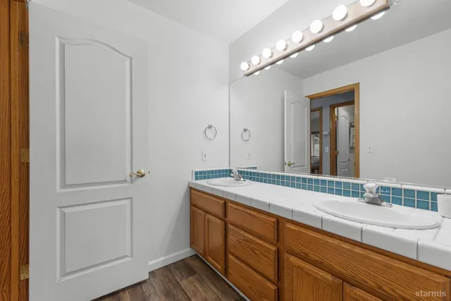 a bathroom with a double vanity sink and a mirror