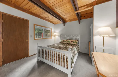 a bedroom with a bed and a lamp