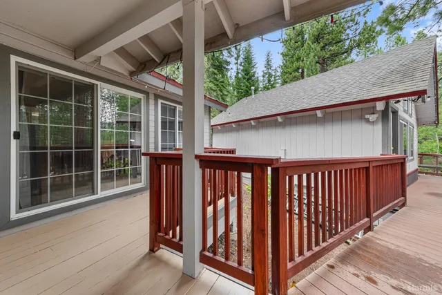 a view of a deck patio with a table and chairs