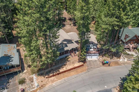 an aerial view of a house with a yard