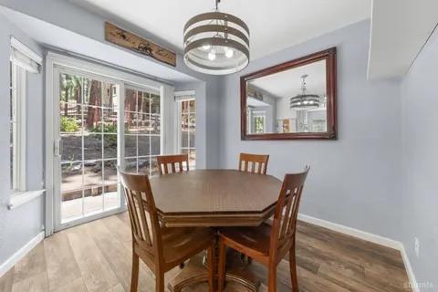 a view of a dining room with furniture wooden floor and a chandelier