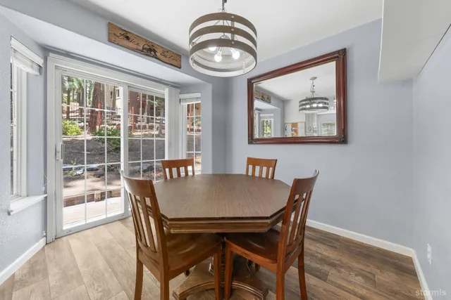 a view of a dining room with furniture wooden floor and a chandelier
