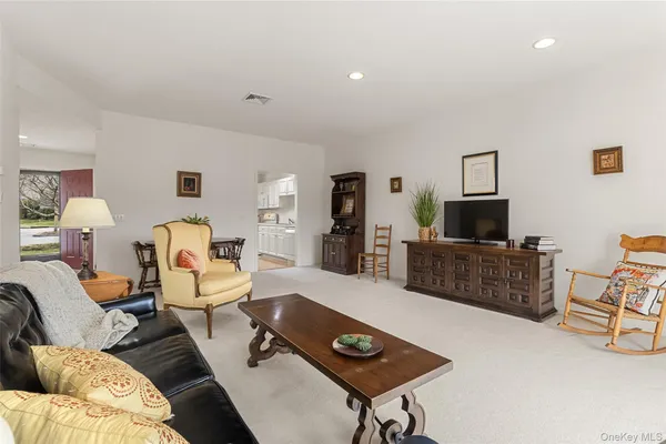 a dining room with furniture and view of kitchen
