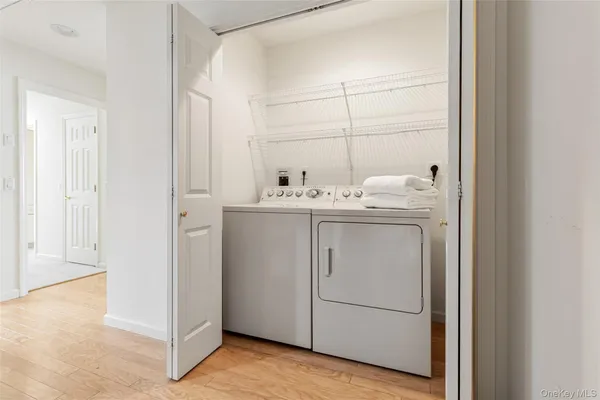 a view of a hallway and a livingroom with furniture