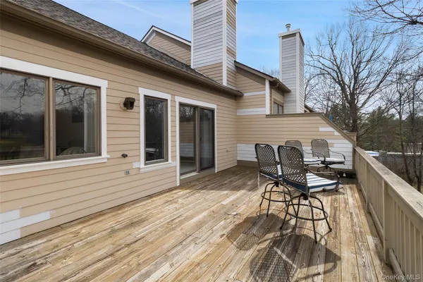 a view of a balcony with chair and wooden floor