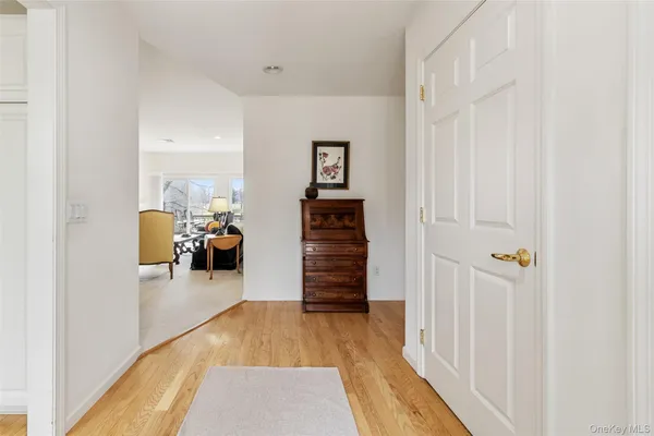 a kitchen with stainless steel appliances granite countertop a refrigerator a stove a sink dishwasher and white cabinets with wooden floor