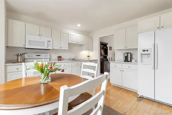 a view of a dining room with furniture and a window