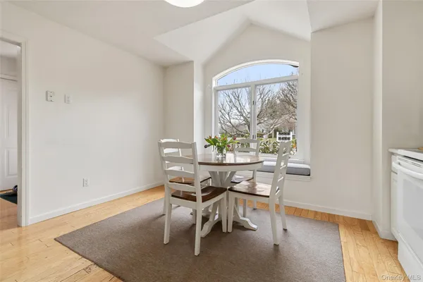 a kitchen with white cabinets and sink